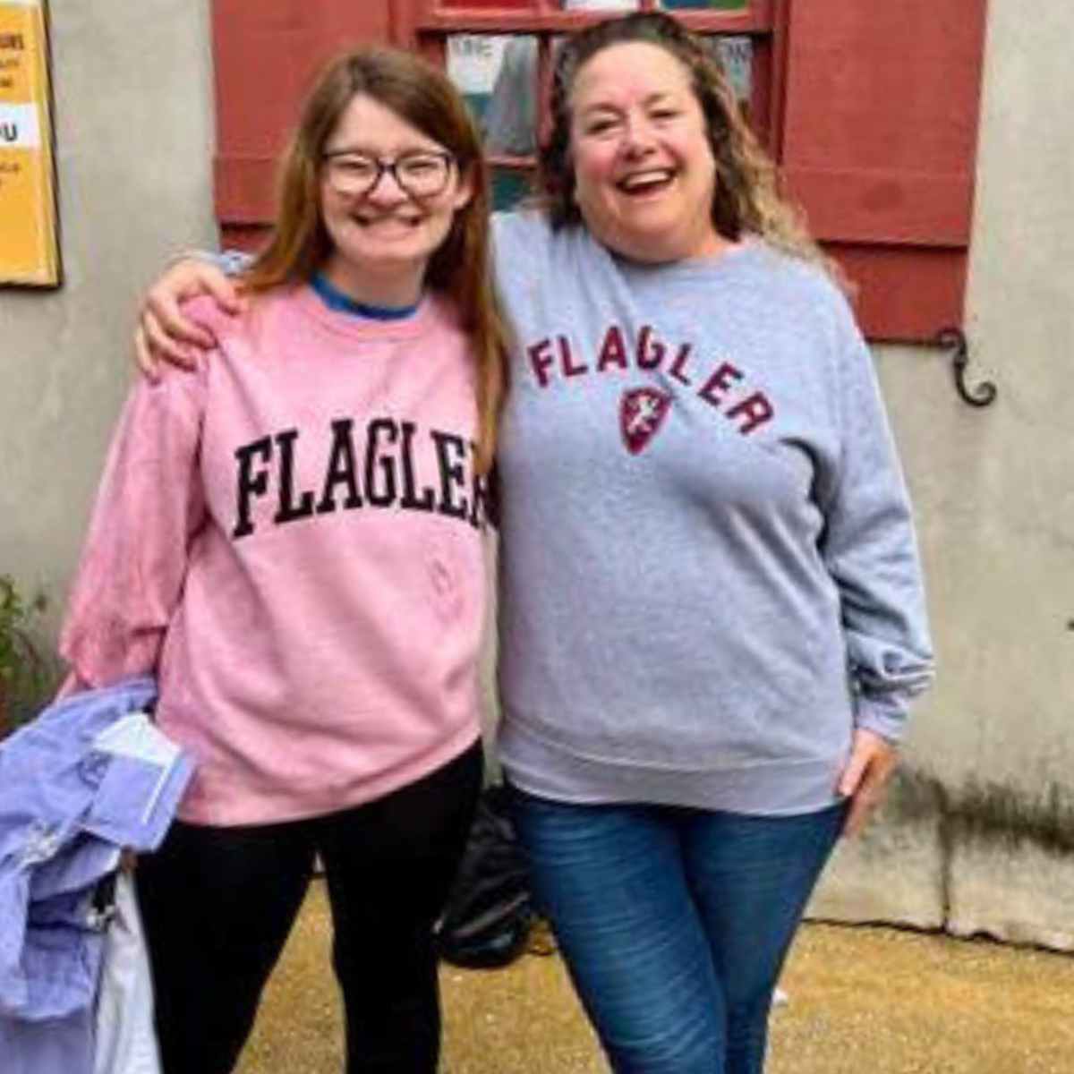 Two women in St. Augustine wearing Flagler College Sweatshirts