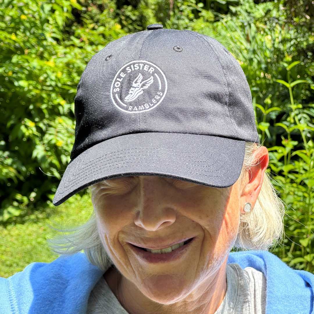 Women wearing black dad cap with Sole Sister Ramblers logo.