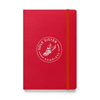 Royal red notebook with round Sole Sister Ramblers logo.
