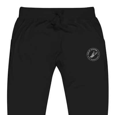 Front view of top of black sweatpants with round Sole Sister Ramblers logo on top leg.