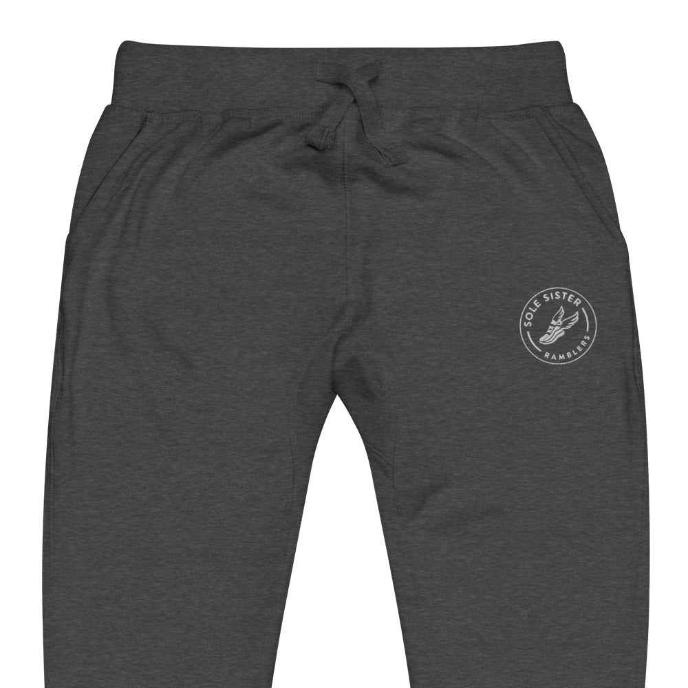 Front view of top of grey sweatpants with round Sole Sister Ramblers logo on top leg.