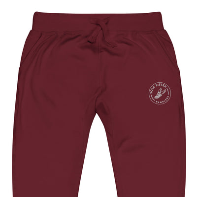 Front view of top of maroon sweatpants with round Sole Sister Ramblers logo on top leg.