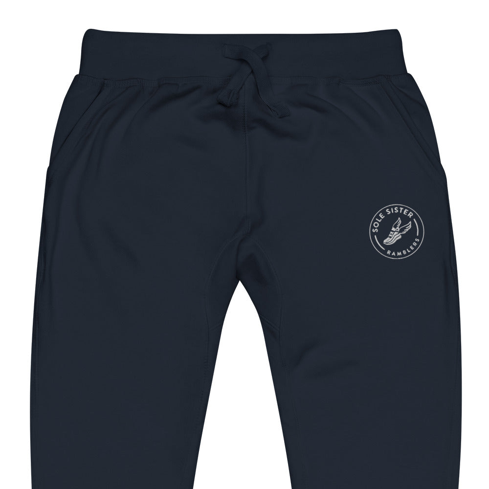 Front view of top of navy sweatpants with round Sole Sister Ramblers logo on top leg.